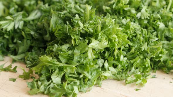 Parsley healthy green vegetable plant smaller pieces on cutting board 4K 3840X2160 UltraHD tilt foot