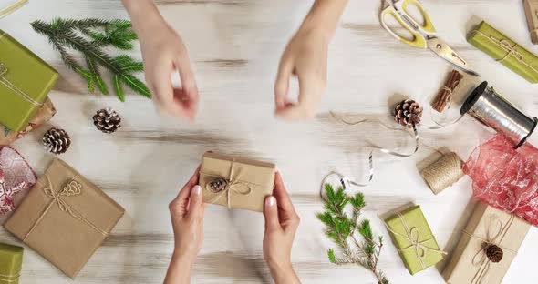 Top View, the Camera Slowly Moves Over Wooden Table, on Which Christmas Decorations, Gifts