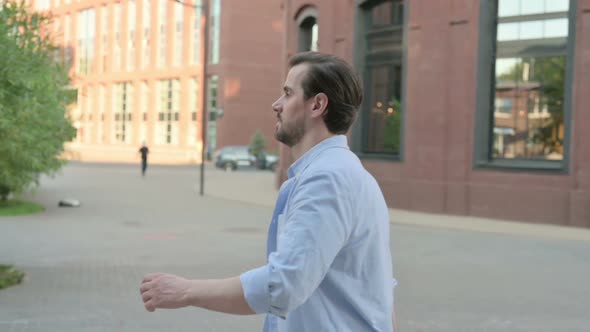 Side Pose of Man Walking in Empty Street in Slow Motion