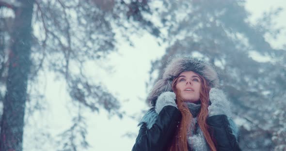 Pretty and Beautiful Girl Walks in the Winter. Snowing. Portrait View