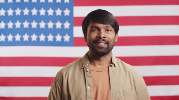Young Indian Man Posing against American Flag