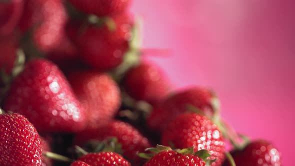 Ripe Juicy Strawberry is Rolling Above Many Strawberries