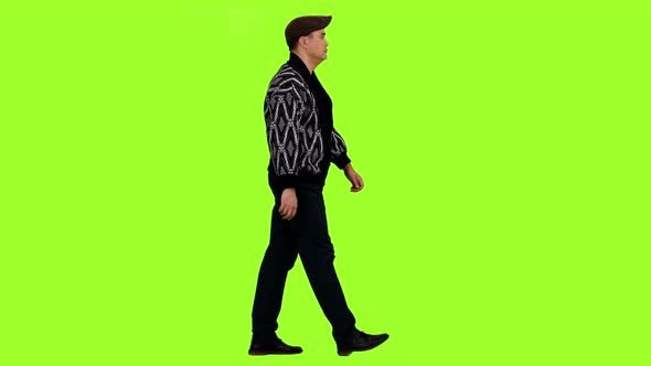 Adult Man in Cardigan and Cap Walks on Green Background, Chroma Key