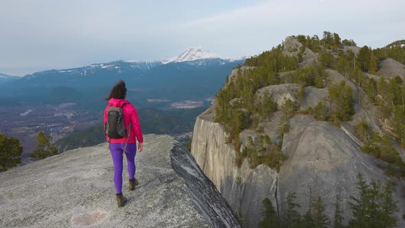 Adventurous Girl Hiking on Top of a Peak