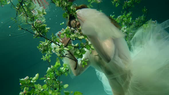 Charming Underwater Princess is Floating in Depth with Fabulous Garden on Sea Bottom