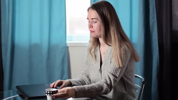 Young fair-haired woman is starting to work from home