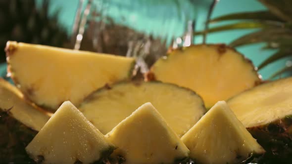 Slow Motion Shot of Pineapple and Water Splashing Through Pineapple Slices