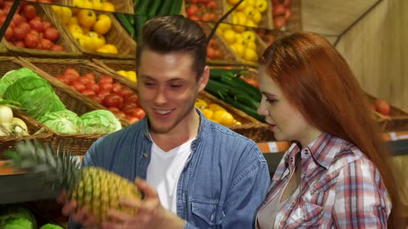 Couple Smells the Pineapple at the Hypermarket