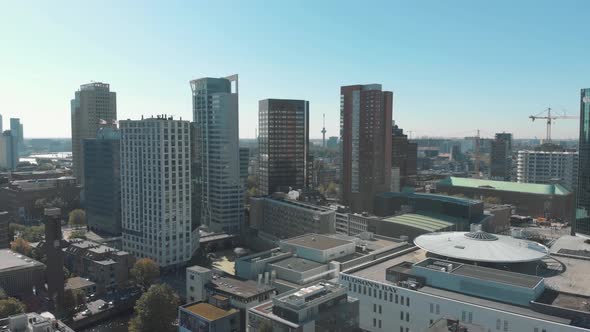 Daytime aerial drone footage of skyscrapers and the cityscape of Rotterdam, Netherlands.