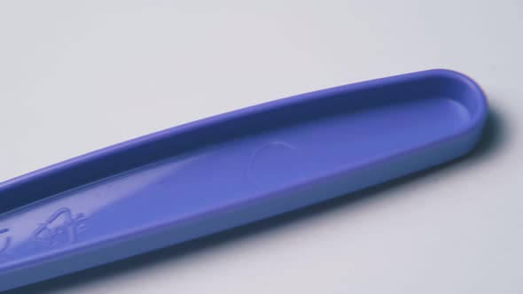 Motion Along Violet Disposable Fork on White Background