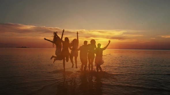 Beach vacations concept. Beauty and joyful teenager friends having fun, dancing, spraying over summe