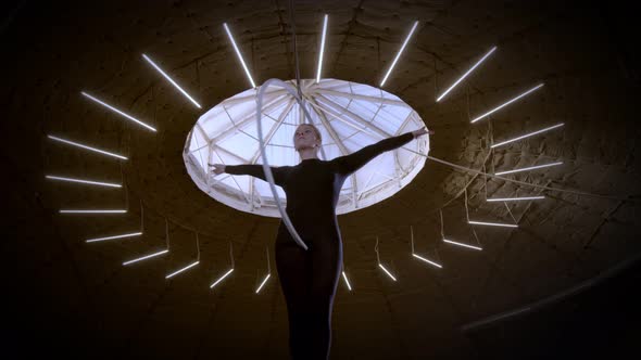 Female Gymnast Performing Dance Elements Spinning Like Jesus on the Aerial Hoop