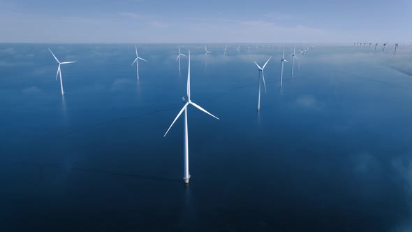 Offshore Windmill Park with Clouds and a Blue Sky Windmill Park in the Ocean Drone Aerial View with