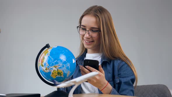 Attractive Happy Woman Spining the Globe