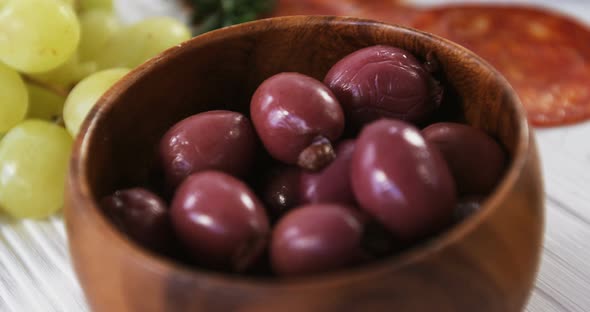 Grapes, red olives, spices and meat