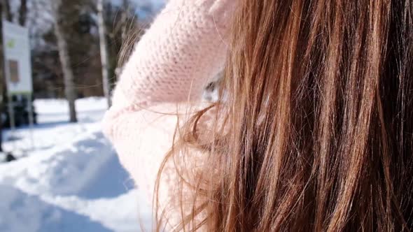 Beautiful Young Woman in Knitted Sweater in Winter Park