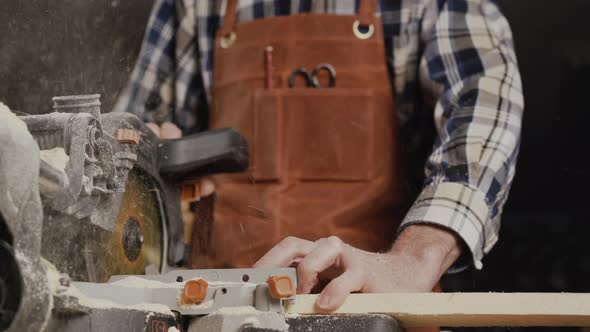 Carpenter Using an Electric Circular Saw Cutting Piece of Wood