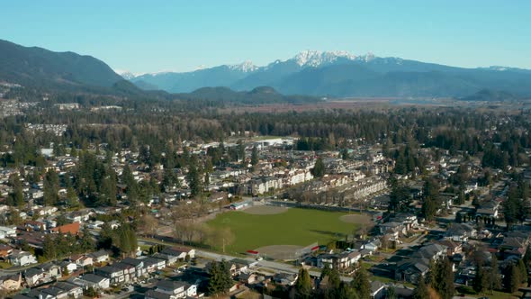 Aerial view of a baseball diamond in an idyllic mountainside community.