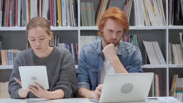 Man Working On Laptop and Woman Using Tablet, Business Team