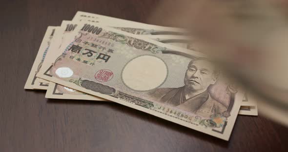 Count with Japanese Yen banknote