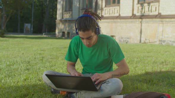 Arab Male Student with Laptop E-learning Outdoors