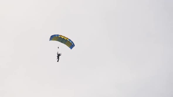 Parachutist is Flying High in the Sky with a Parachute Skydiver Extreme Sport
