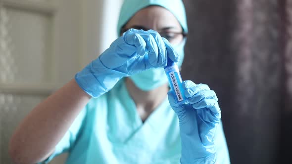 Doctor holding a syringe with the coronavirus COVID-19 vaccine