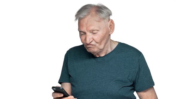 Portrait of Retired Man 80s Having Gray Hair and Blue Eyes Holding Mobile Phone and Finding