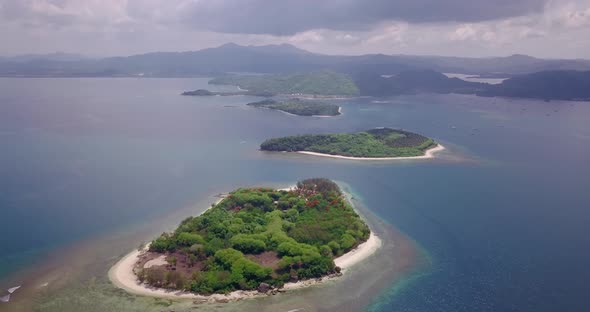 A Top Drone Shot of Island Set with White Sand Beaches and Green Trees