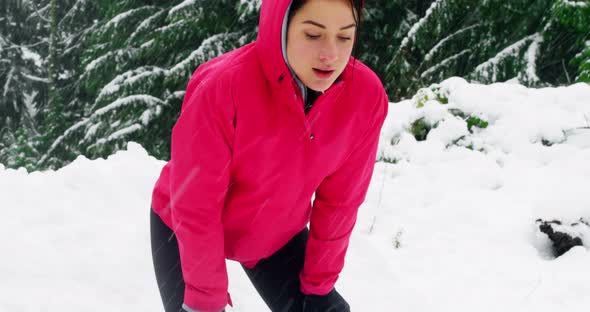 Tired woman taking a break while jogging