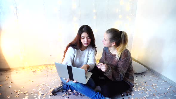 Beautiful Dark-haired Girl Working on Laptop at Home Christmas