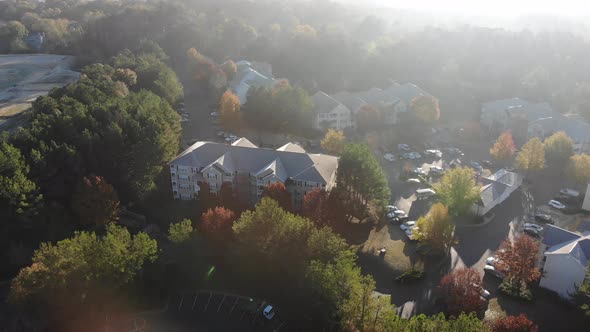 Aerial tilt reveal. Maintenance crew truck early morning apartment complex in Woodstock GA.