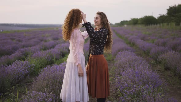 Two Sensual Women Among a Lavender Field Enjoying Time Together