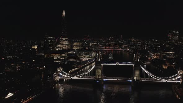 Aerial View to the Illuminated Tower Bridge and Skyline of London at Night UK