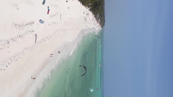 Vertical Video Kitesurfing Near the Shore of Zanzibar Tanzania Aerial View