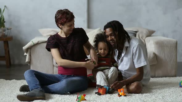 Cheerful Diverse Family with Son Relaxing at Home