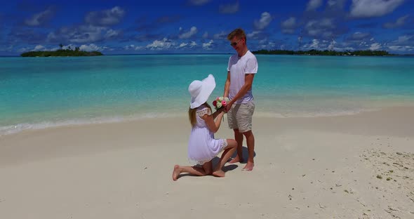 Happy lady and man on honeymoon vacation live the dream on beach on sunny white sandy 4K background