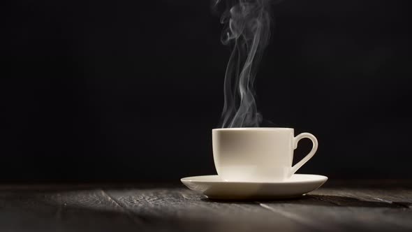 Coffee Cup on Dark Vintage Wooden Background with Steam