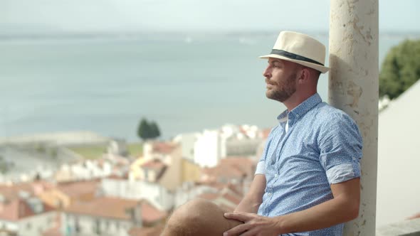 Medium Shot of Happy Man Sitting on Observation Tower