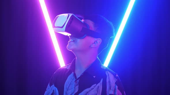 Vr, Futuristic, Excited Asian Boy Using Virtual Reality Headset With Neon Light At The Background