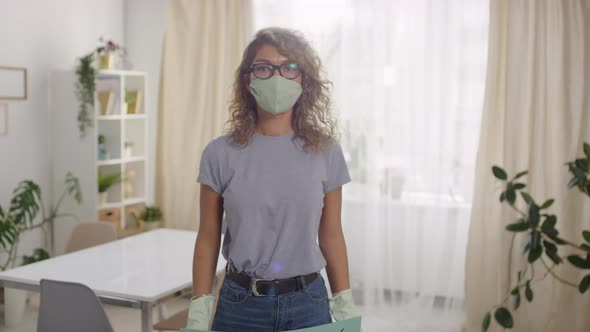 Woman in Face Mask and Gloves Holding Sign