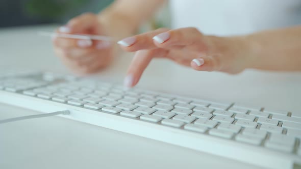 Woman Typing Credit Card Number on Computer Keyboard