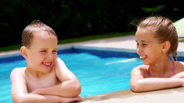 Sibling enjoying in swimming pool