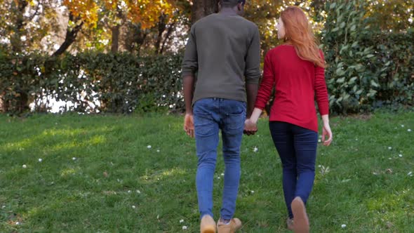 Mixed-Race Couple Holding Hands.Interracial love symbol-slow motion