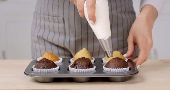 Close Up Shot of Female Chef Preparing Sweet Cupcakes Decorating Pastry with Whipped Cream