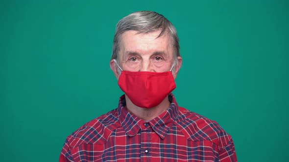 Portrait of Mature Man in Protective Red Medical Face Mask