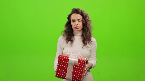 The Woman is Standing and Looking at the Camera