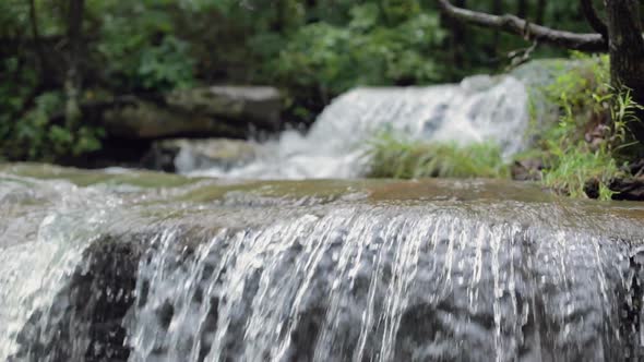 Flowing Water in a Creek Over a Cliff in Slow Motion