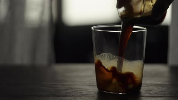 Slow Motion Making Espresso Tonic in Tumbler Glass Pour Espresso in Glass