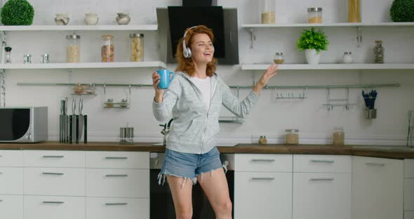 Young Woman Is Dancing in Her New Kitchen